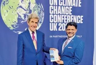 A-G meets Kerry: Attorney-General and Minister for Climate Change Aiyaz Sayed-Khaiyum had the opportunity to present a copy of Fiji’s Climate Change Act to the first United States Special Presidential Envoy for Climate, John Kerry. Photo: Office of the Attorney-General